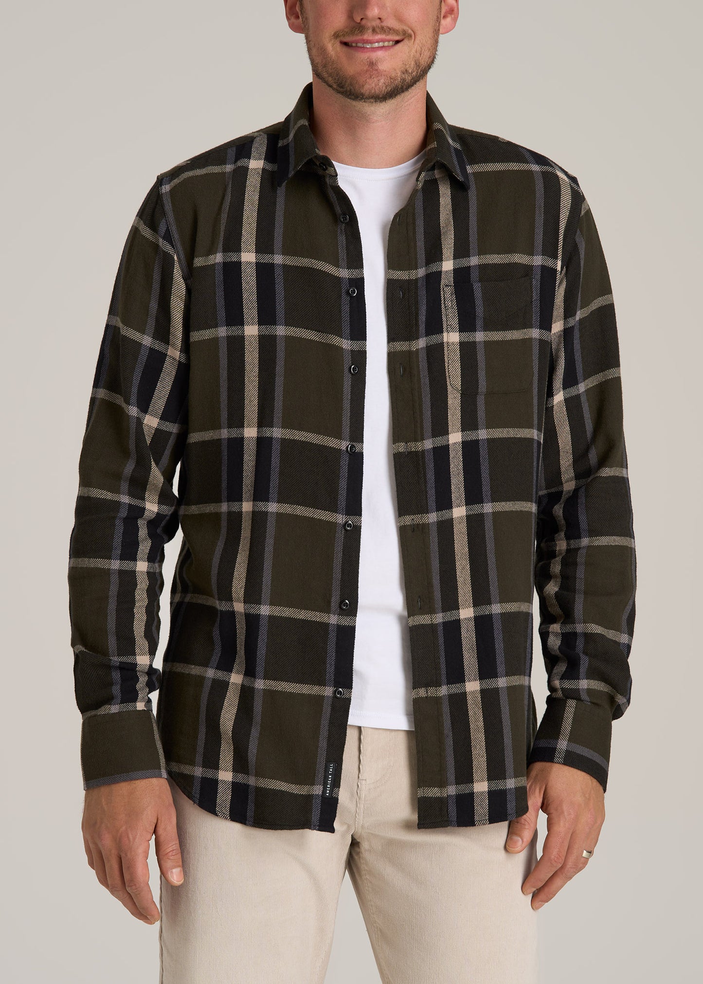 A tall man wearing American Tall's Nelson Flannel Shirt for Tall Men in Olive Plaid