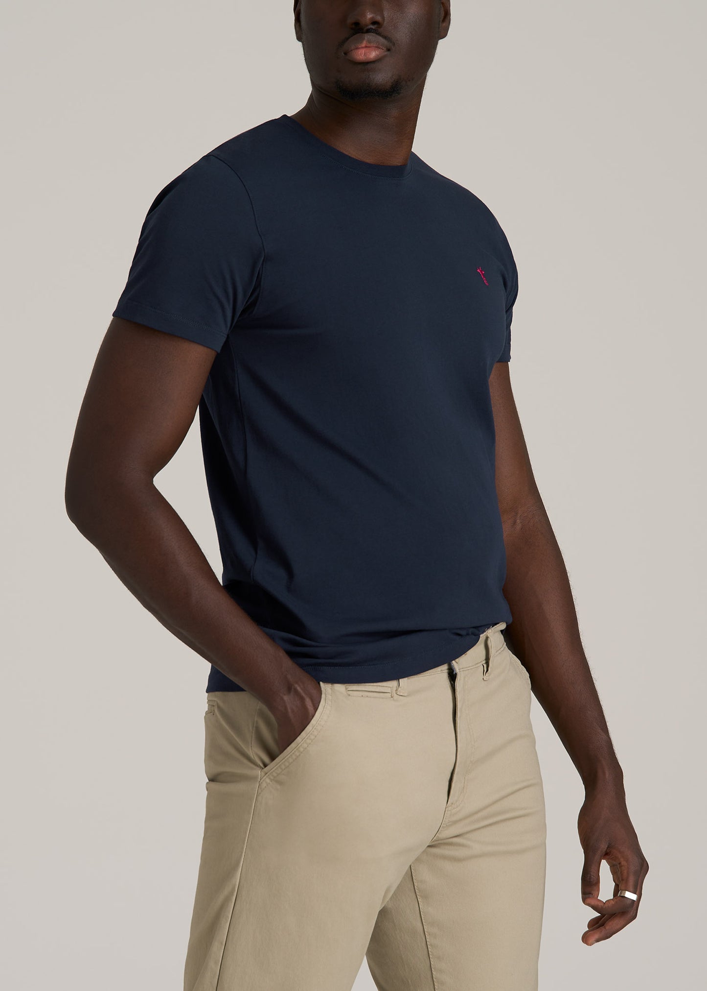 A tall man wearing American Tall's MODERN-FIT Embroidered Logo Crewneck T-Shirt for Tall Men in Evening Blue