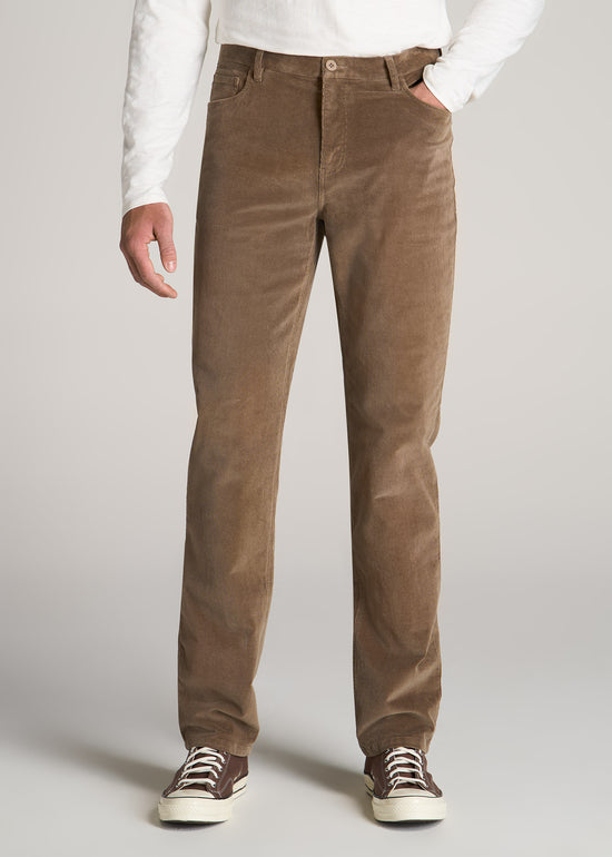 Tall man wearing American Tall's 5 Pocket Stretch Corduroy in Dark Sand.