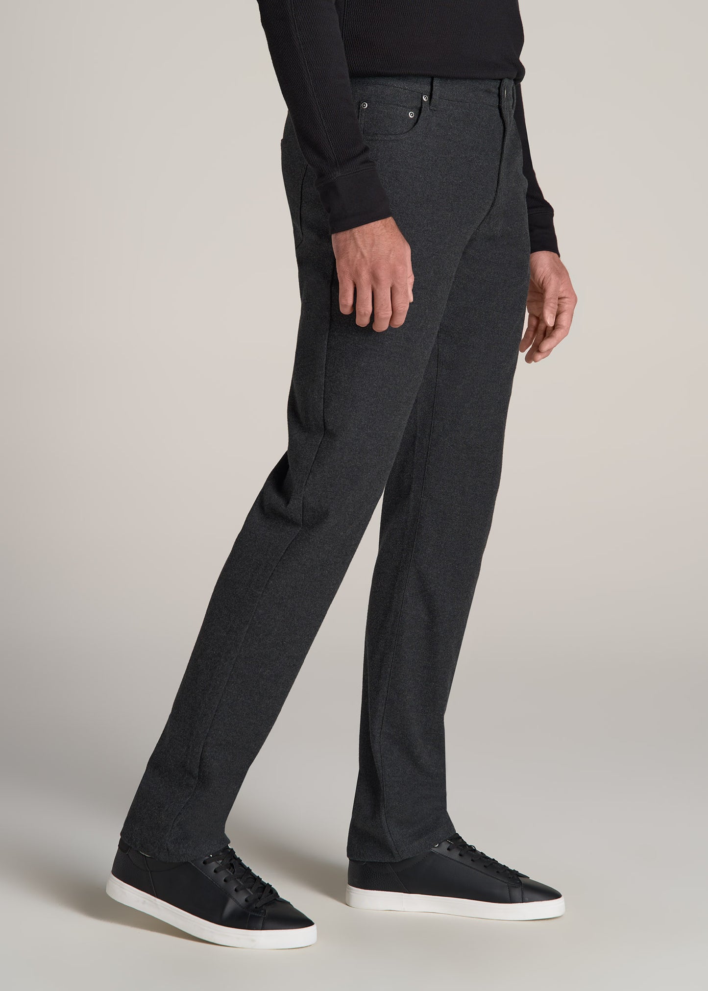 A tall man wearing American Tall's TAPERED-FIT Stretch Flannel 5 Pocket Pants for Tall Men in Storm Grey Mix