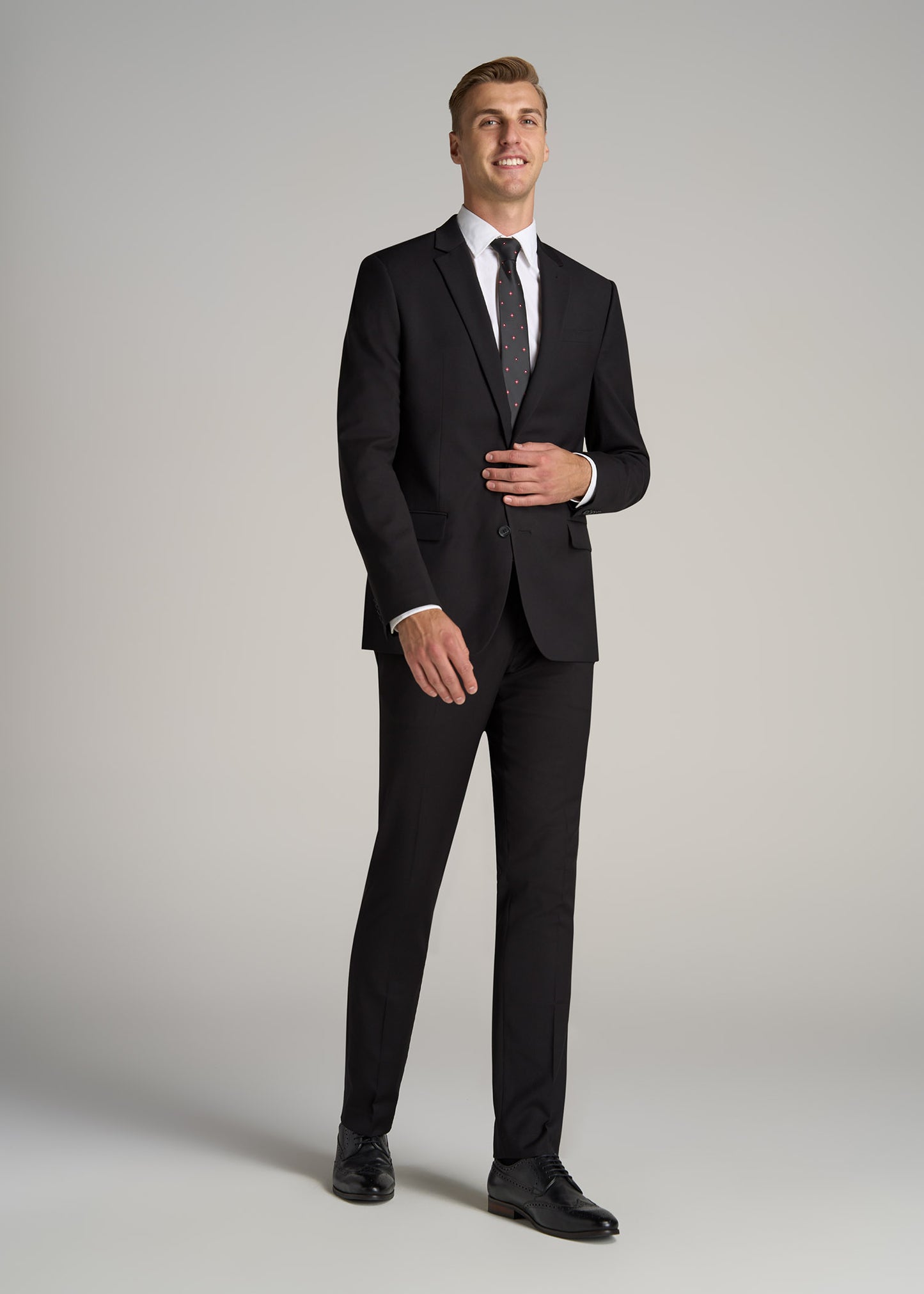 A tall man wearing American Tall's Suit Jacket for Tall Men in Black