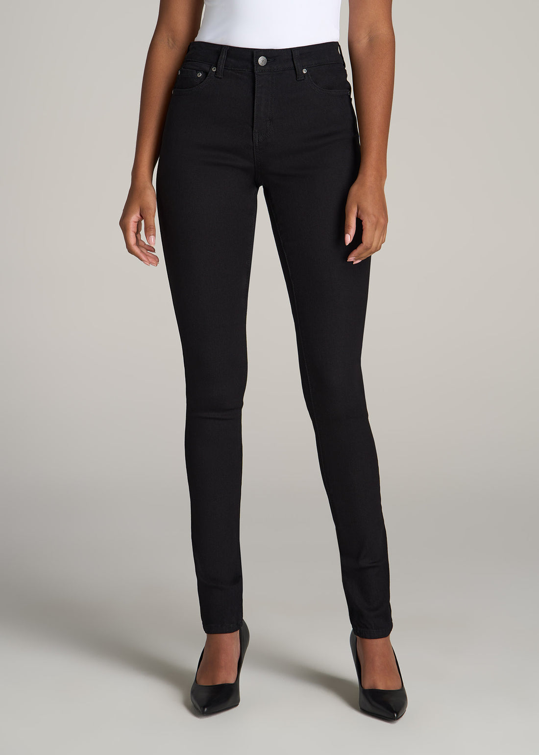 Tall woman wearing American Tall Sarah Mid Rise Skinny Jean in Black