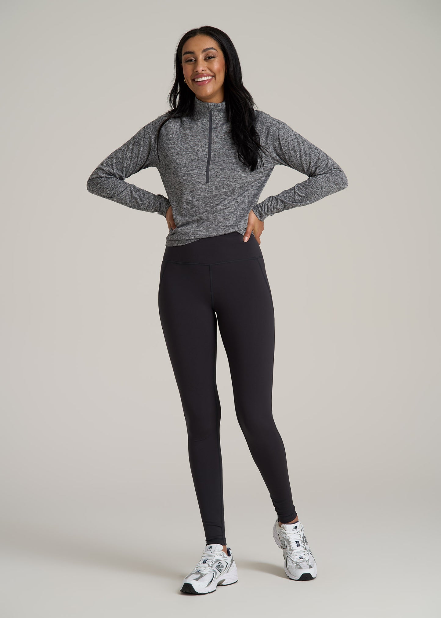 A tall woman wearing American Tall's Fleece Lined Women's Tall Leggings in Storm Grey