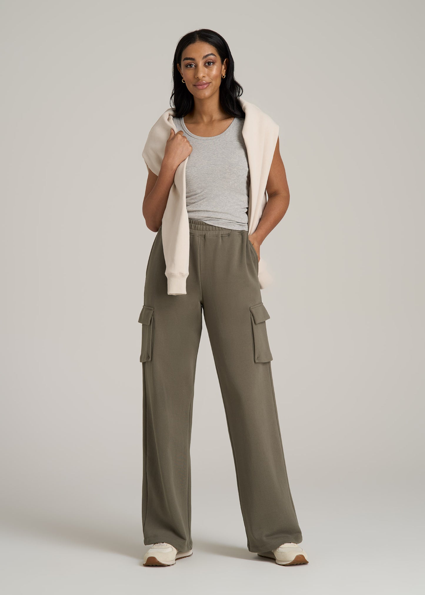 A tall woman wearing American Tall's French Terry Wide Leg Cargo Sweatpants for Tall Women in Camper Green