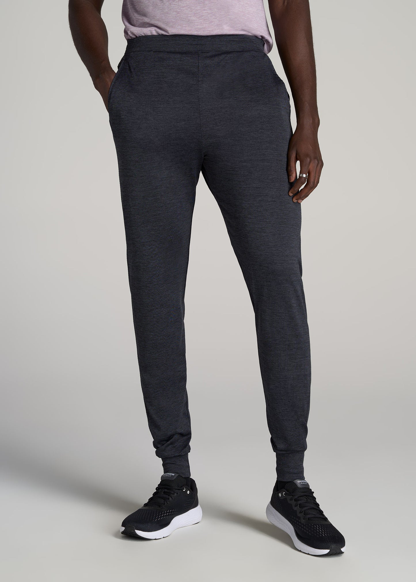 A tall man wearing American Tall's A.T. Performance Engineered Joggers for Tall Men in Charcoal Mix