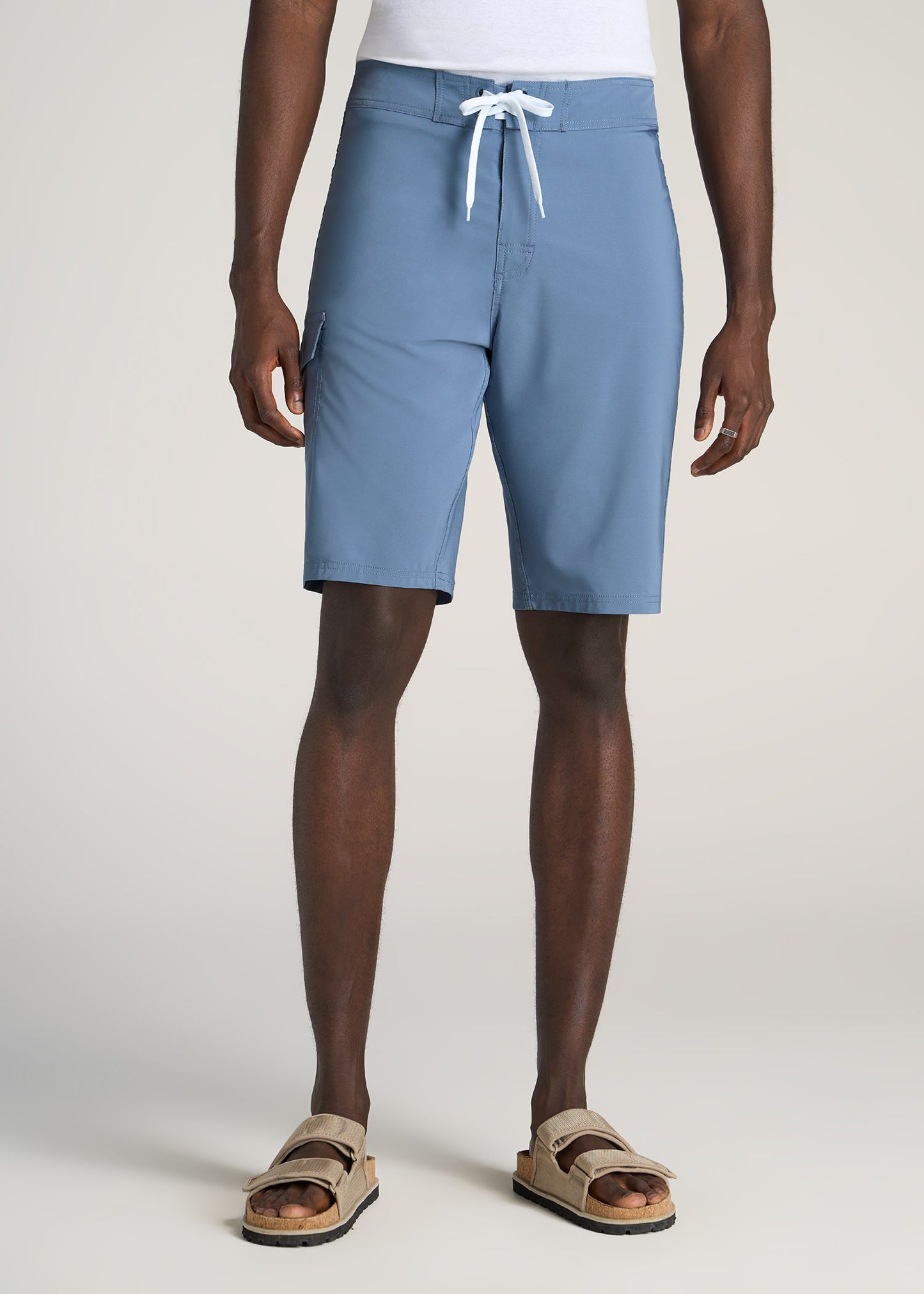 A tall man wearing American Tall's Tall Board Shorts for Men in Chambray.