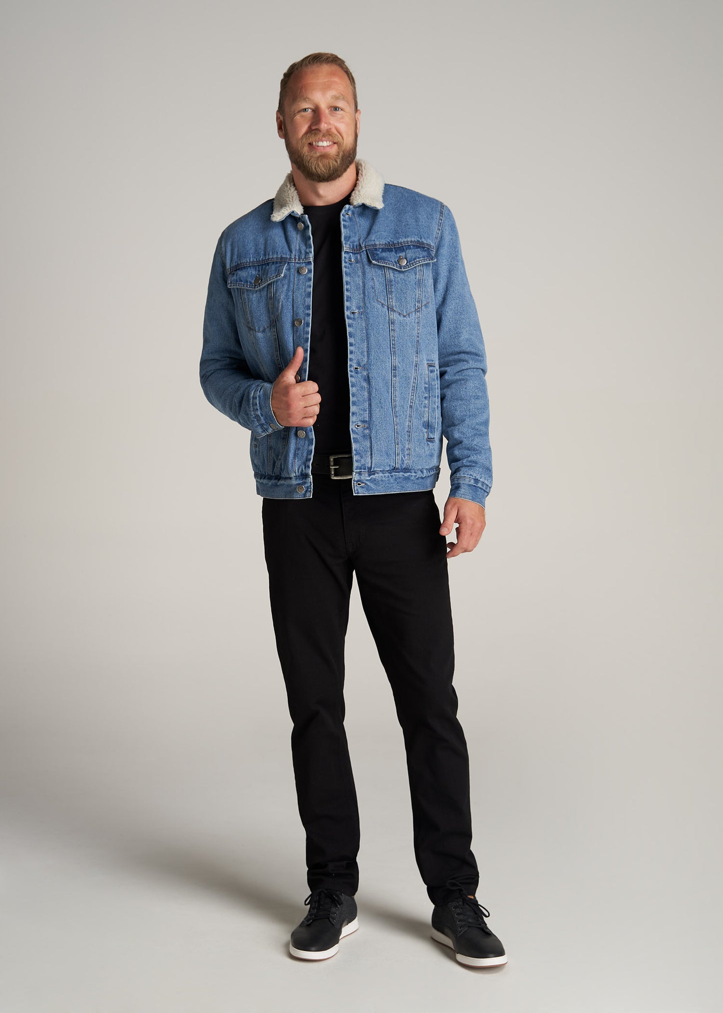 A tall man wearing American Tall's Denim Sherpa Tall Men's Jacket in Stonewash Blue