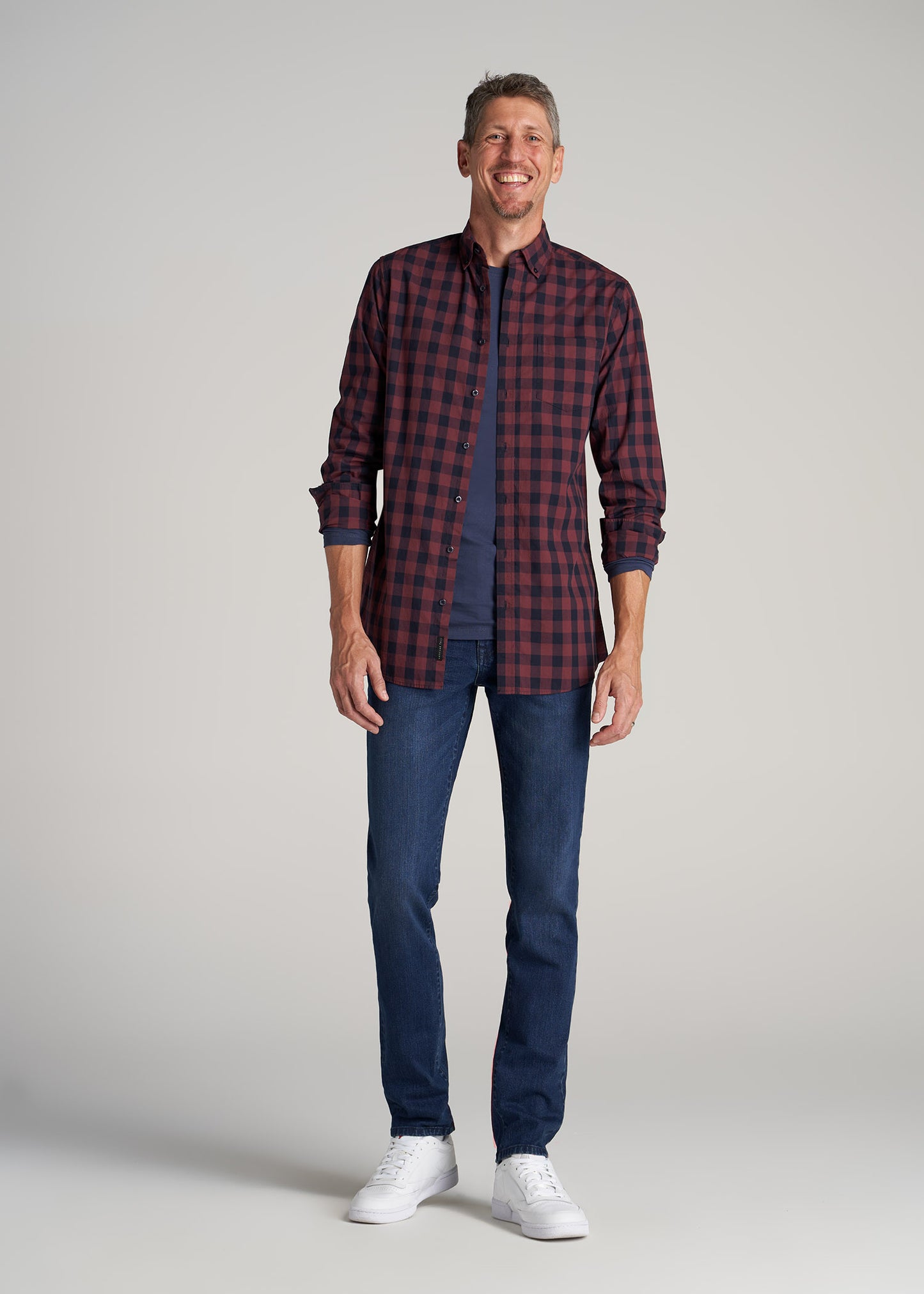 A tall man wearing American Tall's Dylan SLIM-FIT Jeans for Tall Men in Atlantic Blue