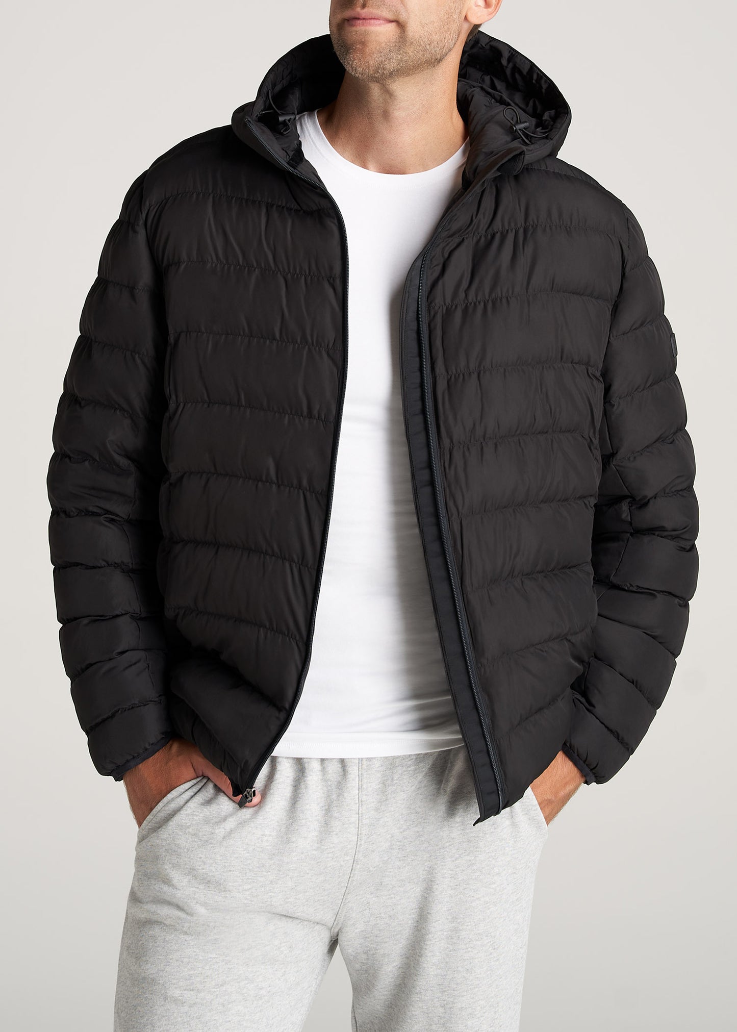 Man wearing the American Tall Medium Weight Puffer Jacket in Black