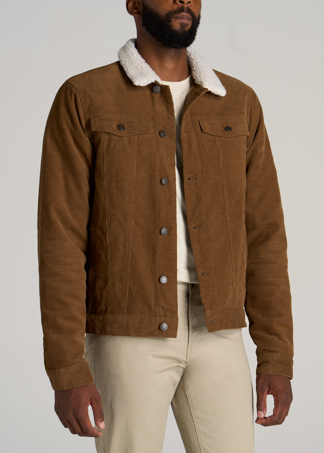 Tall man wearing Longjohn & Sons Men's Sherpa Corduroy Trucker Jacket in Tan Brown