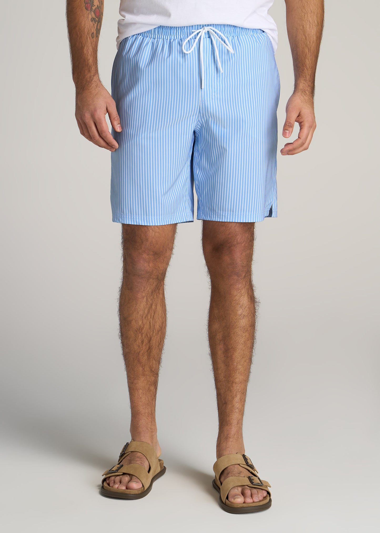 A tall man wearing American Tall's Swim Shorts for Tall Men in Sky Blue Stripe.