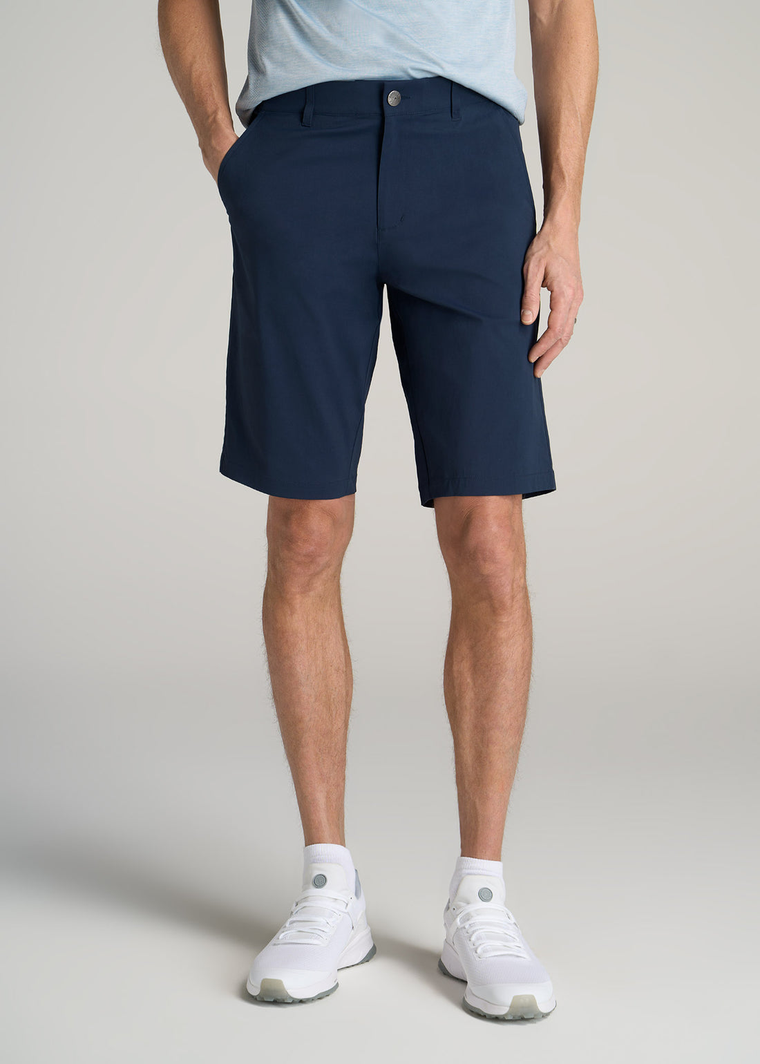 Tall slim man wearing American Tall's Traveler Chino Shorts in a marine navy color.