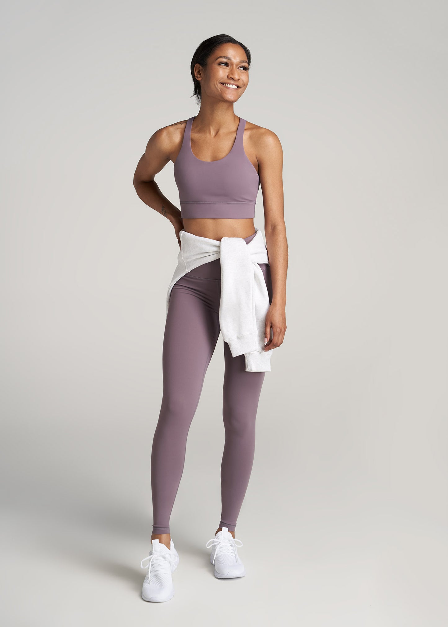 A tall woman wearing American Tall's Women's Balance Crisscross Tall Sports Bra in Smoked Mauve