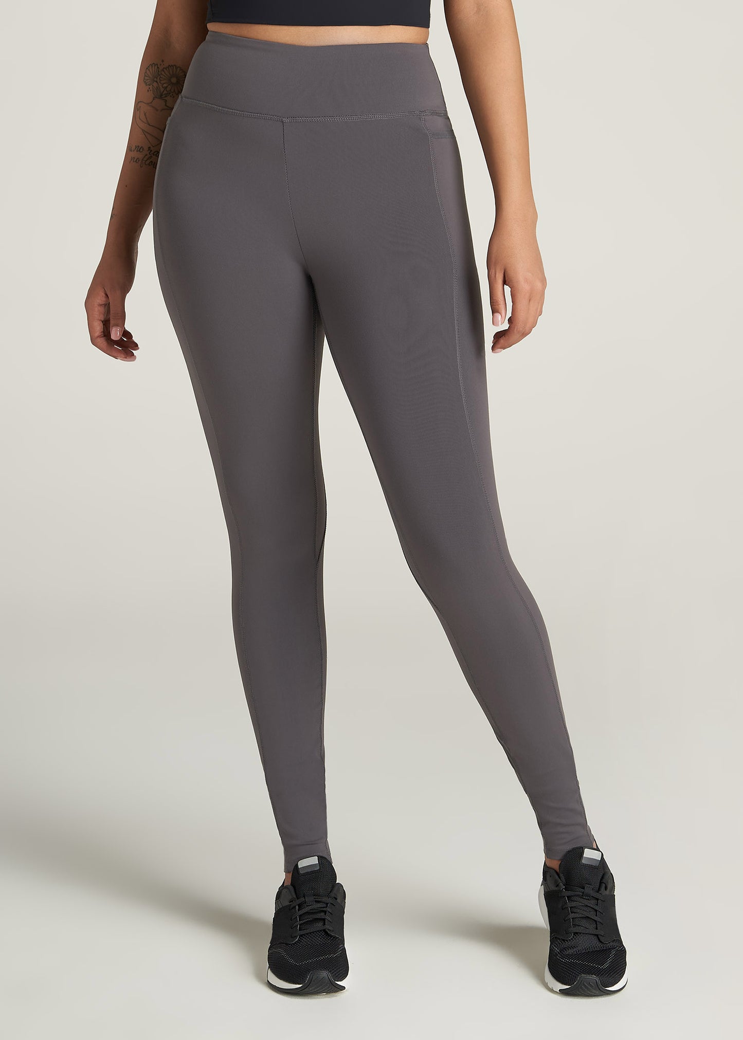 A tall woman wearing American Tall's Pocket Legging in Charcoal.