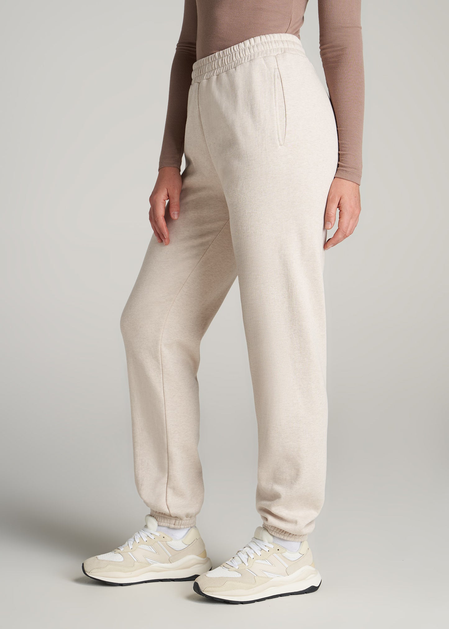 A tall woman wearing American Tall's Wearever Fleece Relaxed Women's Tall Sweatpants in Oatmeal Mix.